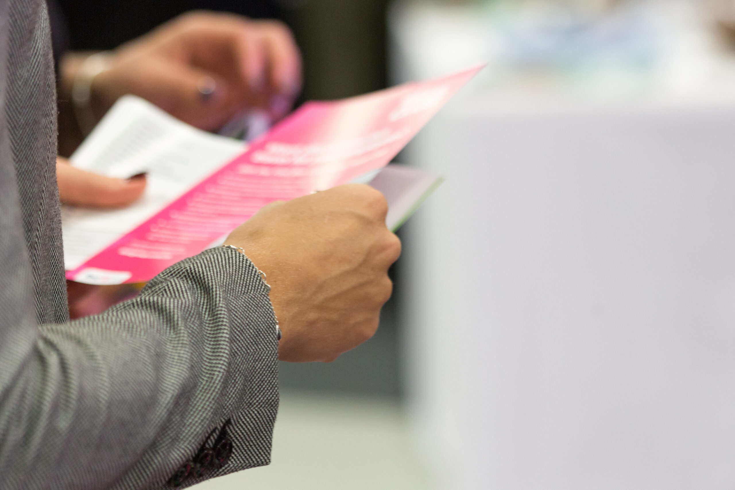 Female,Holding,A,Leaflet,,Close,Up,,Blurred,,Space,For,Text,